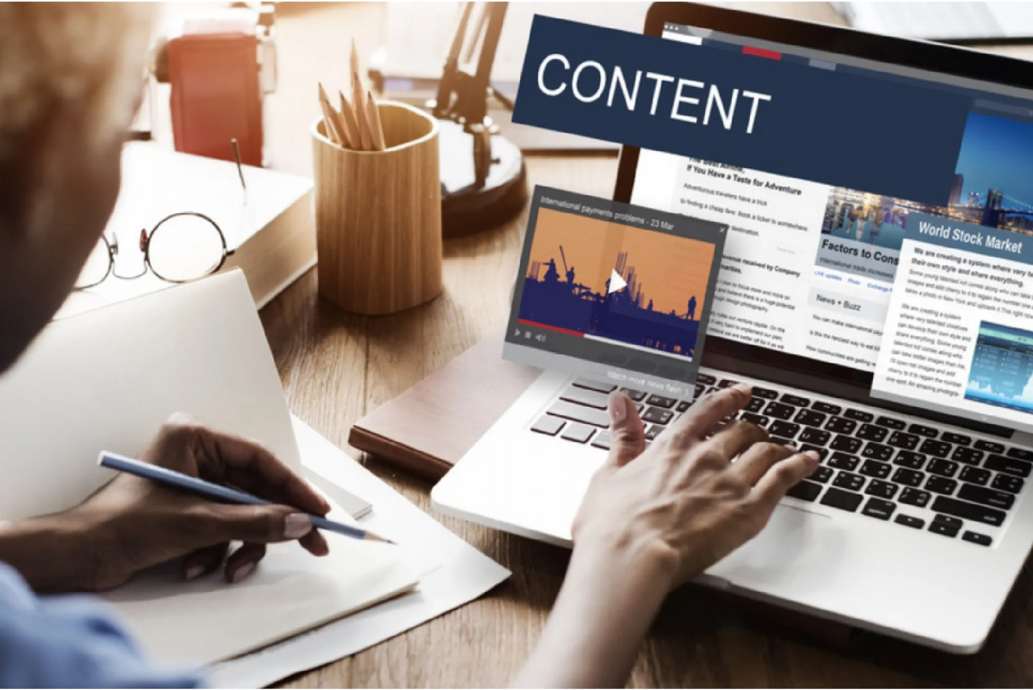 Person creating digital content on a laptop, with articles, videos, and media elements displayed on the screen