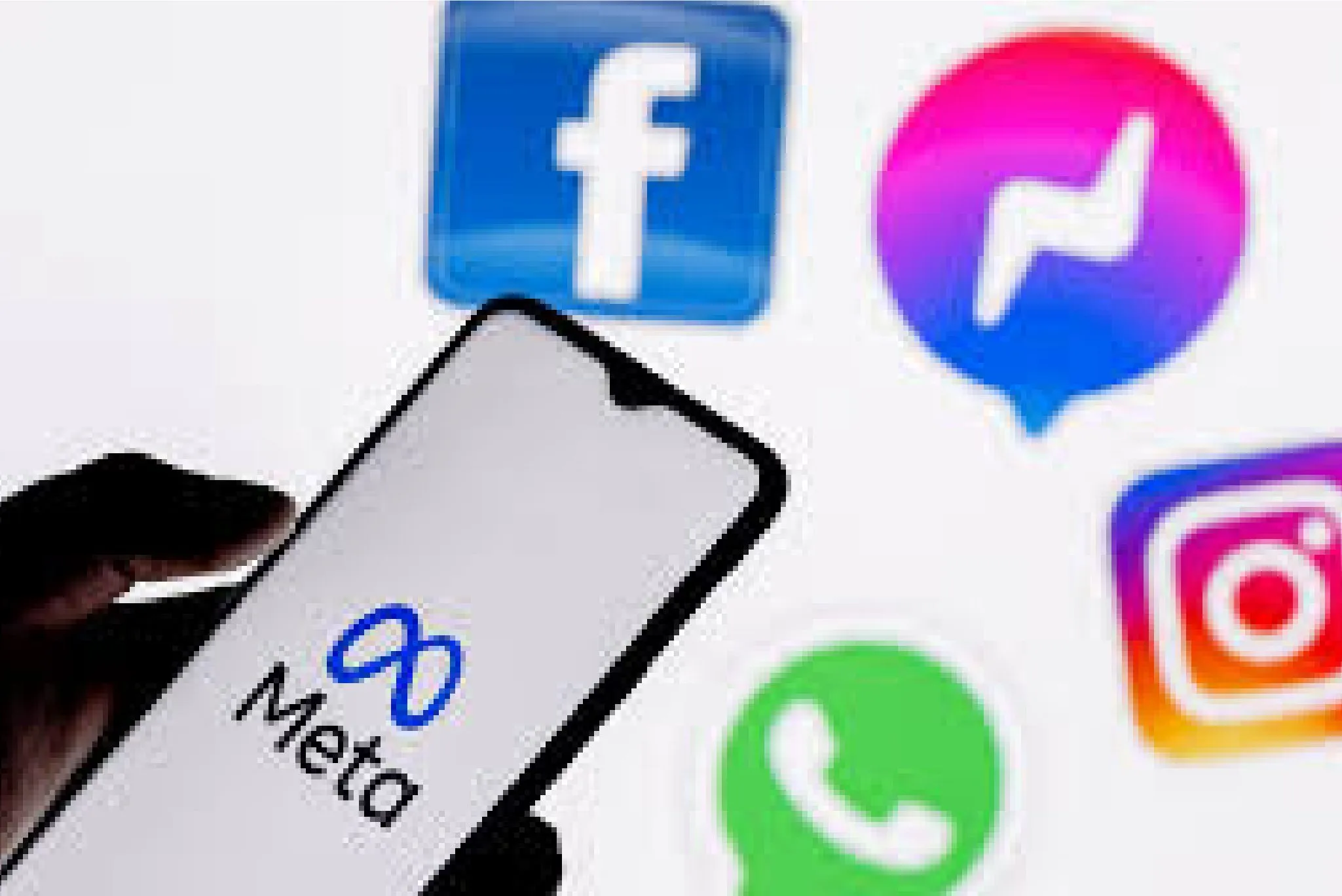 Meta logo on a smartphone screen with Facebook, Messenger, Instagram, and WhatsApp logos in the background.
