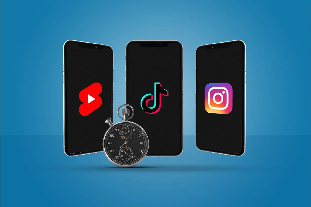 Three smartphones displaying YouTube Shorts, TikTok, and Instagram Reels logos with a stopwatch, representing short video content platforms.
